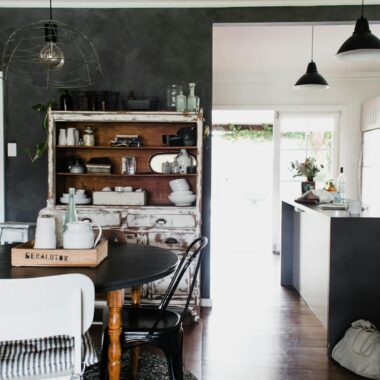 A beautifully designed rustic dining room featuring vintage furniture, natural light, and elegant decor.